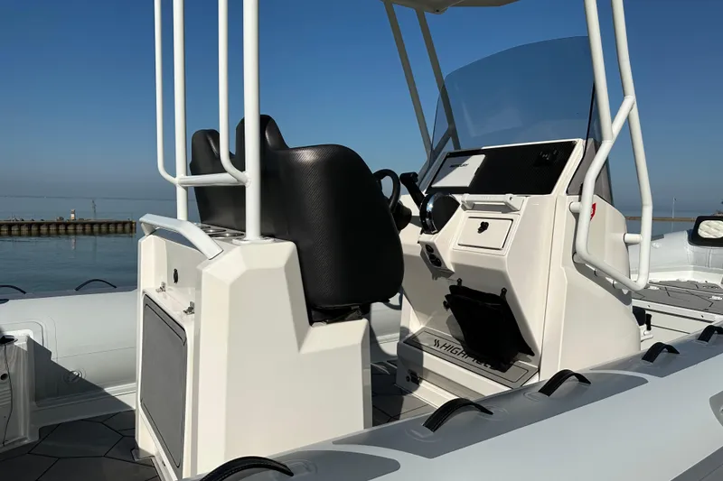 Slide: The Image of 2024 Highfield Sport 660 boat interior with steering console and seating. - 3