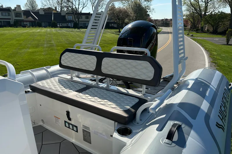 Slide: The Image of 2024 Highfield Sport 660 boat with cushioned seating and sleek design on a sunny day. - 6