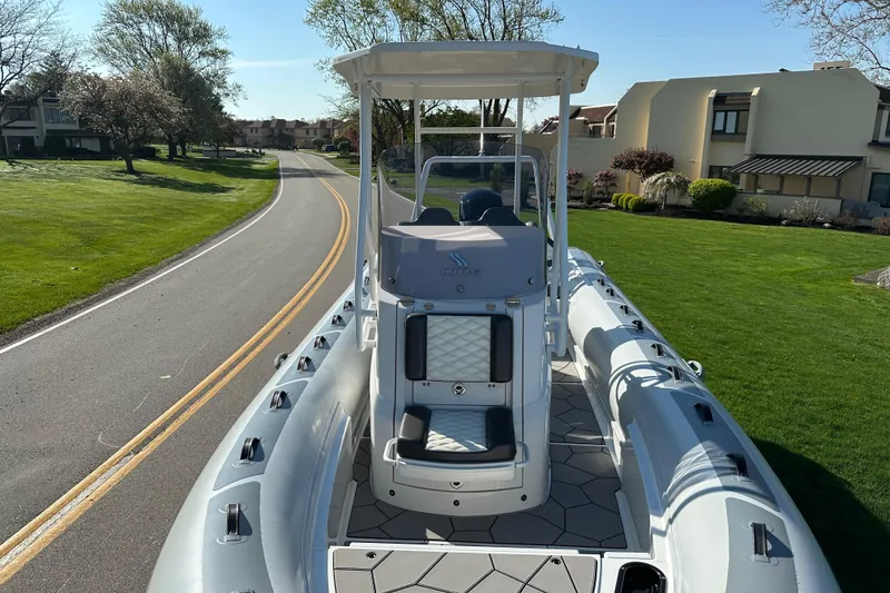 Slide: The Image of 2024 Highfield Sport 660 boat on a road, showcasing sleek design and modern features. - 9