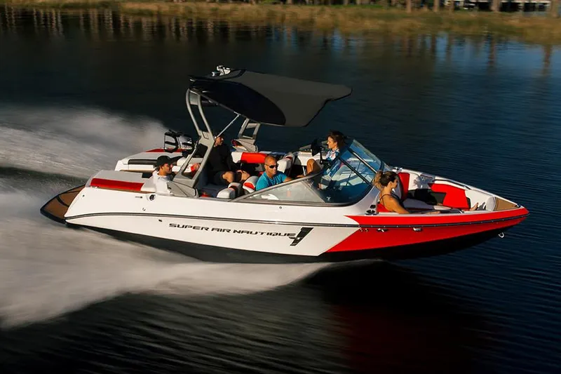 Slide: The Image of Manufacturer Provided Image: 2020 Nautique Super Air Nautique 210 speedboat cruising on a lake with passengers. - 5