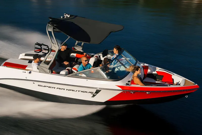 Slide: The Image of Manufacturer Provided Image: 2020 Nautique Super Air Nautique 210 speedboat cruising on water with passengers. - 6