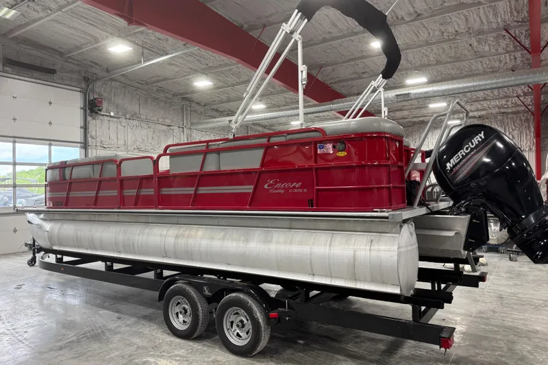Slide: The Image of 2014 Bentley Pontoons 243 Cruise in a warehouse, featuring a red exterior and Mercury outboard motor. - 3
