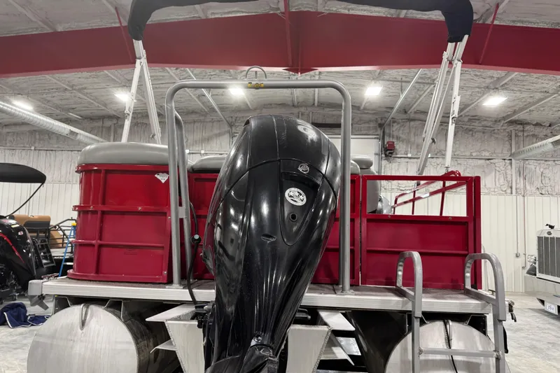 Slide: The Image of 2014 Bentley Pontoons 243 Cruise with outboard motor in a storage facility. - 5