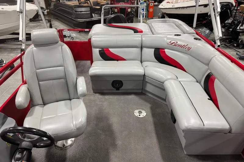 Slide: The Image of 2014 Bentley Pontoons 243 Cruise interior with gray and red seating in showroom. - 8