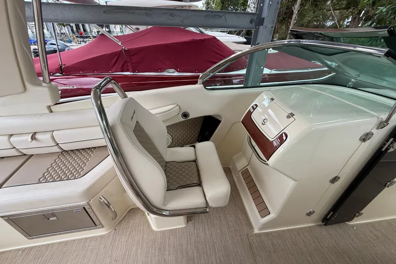 Slide: The Image of 2024 Chris-Craft Launch 28 GT boat interior with luxurious seating and outboard motor. - 12
