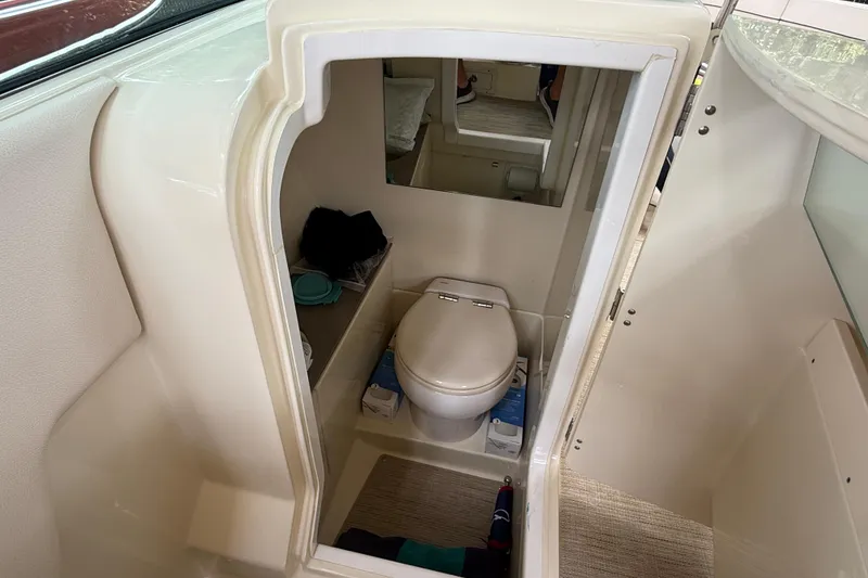 Slide: The Image of 2024 Chris-Craft Launch 28 GT storage compartment with open hatch, showcasing interior details. - 13