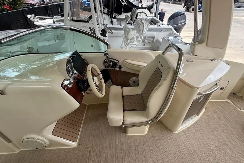 Slide: The Image of Luxurious seating area on 2024 Chris-Craft Launch 28 GT boat, featuring elegant beige upholstery. - 14
