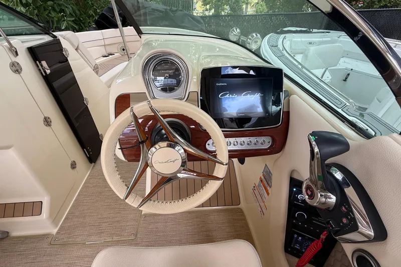 Slide: The Image of 2024 Chris-Craft Launch 28 GT dashboard with steering wheel and modern controls. - 20