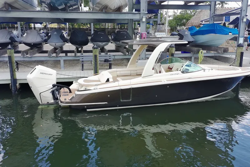 Slide: The Image of 2024 Chris-Craft Launch 28 GT boat docked, featuring sleek design and Mercury outboard engine. - 25