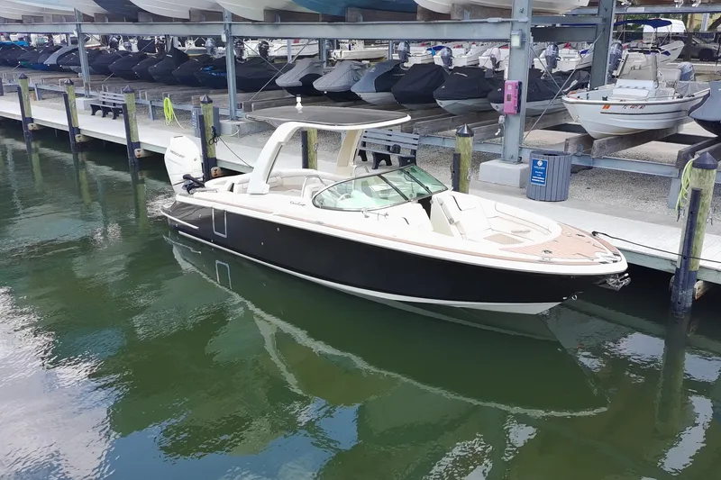Slide: The Image of 2024 Chris-Craft Launch 28 GT boat docked in marina, showcasing sleek design and luxury features. - 26