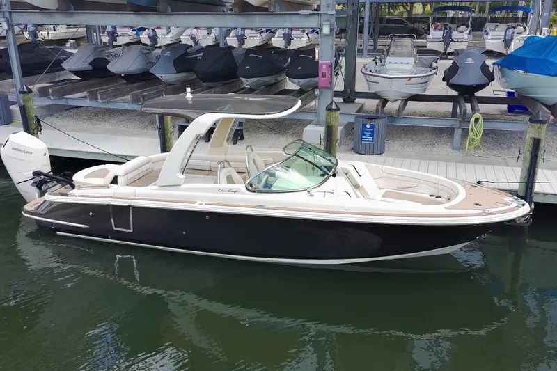 Slide: The Image of 2024 Chris-Craft Launch 28 GT boat docked in marina, showcasing sleek design and luxury features. - 28