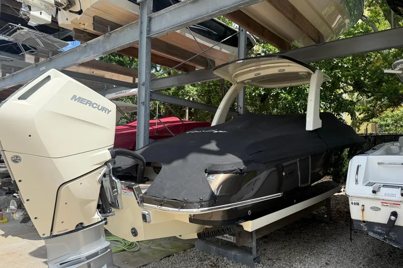 Slide: The Image of 2024 Chris-Craft Launch 28 GT boat docked, showcasing elegant design and spacious seating. - 3