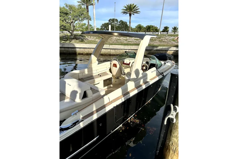 Slide: The Image of 2024 Chris-Craft Launch 28 GT boat docked, featuring sleek design and luxurious seating. - 30