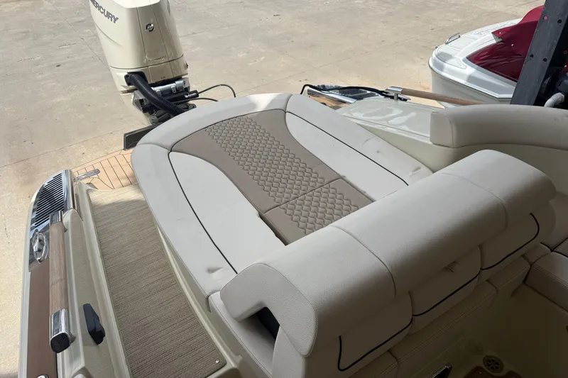 Slide: The Image of 2024 Chris-Craft Launch 28 GT boat docked, featuring sleek design and Mercury outboard engine. - 5