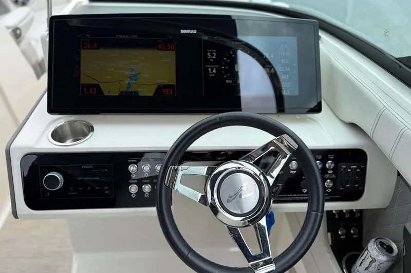 Slide: The Image of 2022 Sea Ray SLX 280 dashboard with steering wheel and navigation display. - 15
