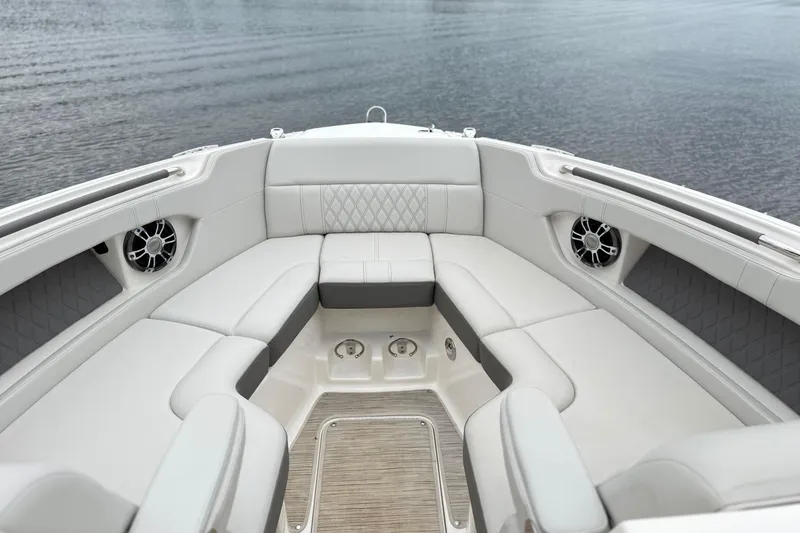 Slide: The Image of Luxurious seating area on 2022 Sea Ray SLX 280 boat, featuring elegant upholstery and speakers. - 18