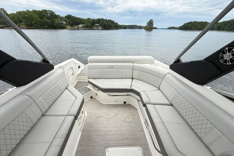 Slide: The Image of Luxurious 2022 Sea Ray SLX 280 boat interior with spacious seating, overlooking a serene lake. - 22