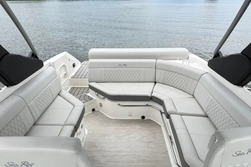 Slide: The Image of Luxurious seating on 2022 Sea Ray SLX 280 boat, overlooking calm waters. - 23
