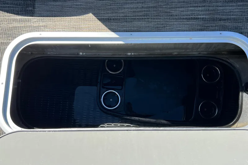 Slide: The Image of Storage compartment on 2023 Godfrey Monaco 235 SB boat, featuring cup holders. - 23