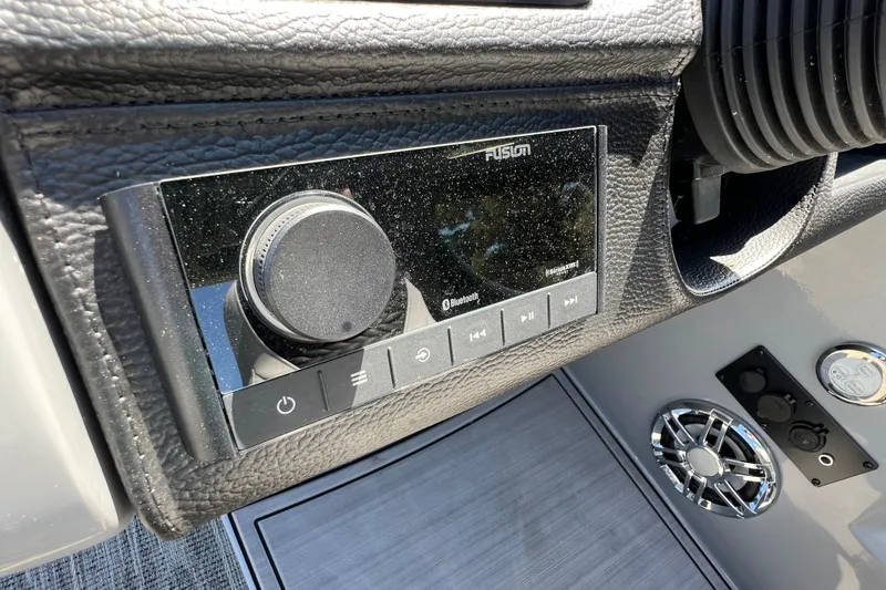 Slide: The Image of 2023 Godfrey Monaco 235 SB boat dashboard with Fusion audio system and controls. - 25