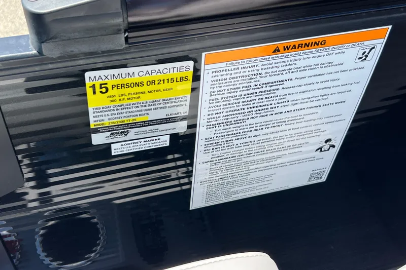 Slide: The Image of 2023 Godfrey Monaco 235 SB capacity and safety warning labels on boat interior. - 28