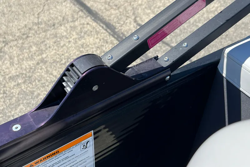 Slide: The Image of Close-up of 2023 Godfrey Monaco 235 SB boat railing and warning label. - 29