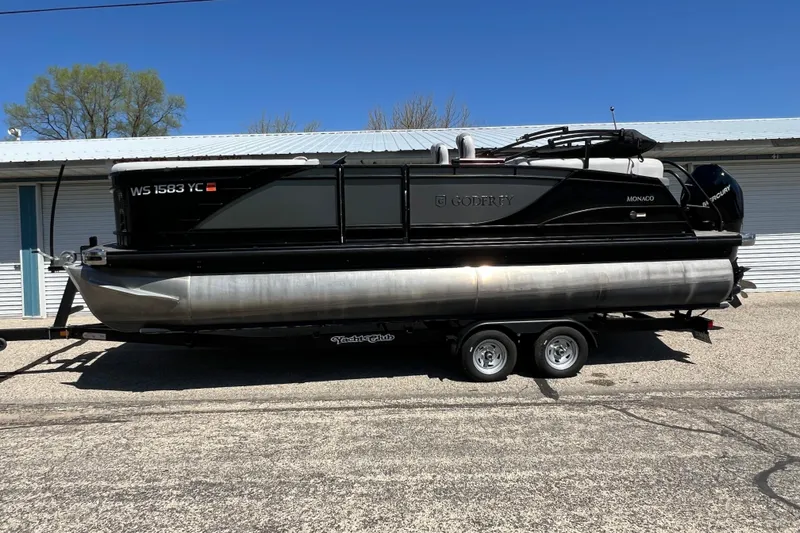 Slide: The Image of 2023 Godfrey Monaco 235 SB pontoon boat on trailer, parked outdoors. - 3