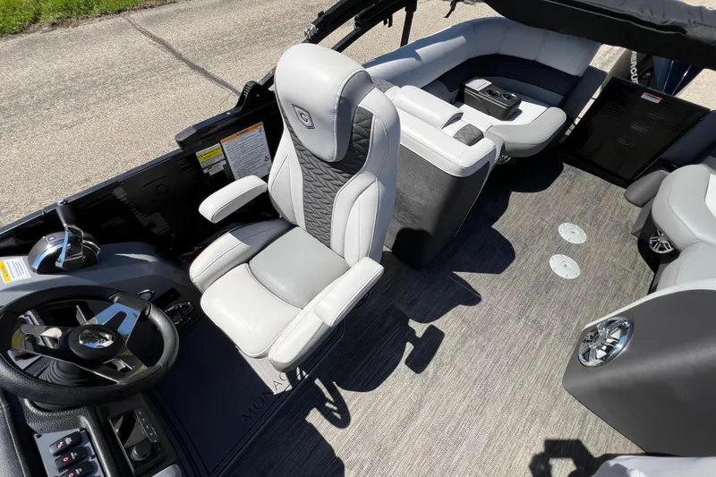 Slide: The Image of 2023 Godfrey Monaco 235 SB boat interior with luxurious seating and modern steering console. - 32