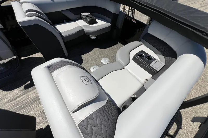 Slide: The Image of Luxurious seating on 2023 Godfrey Monaco 235 SB pontoon boat, featuring cup holders and premium upholstery. - 36