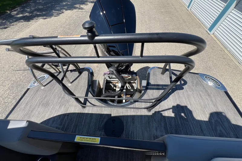 Slide: The Image of 2023 Godfrey Monaco 235 SB boat deck with railing and motor. - 39