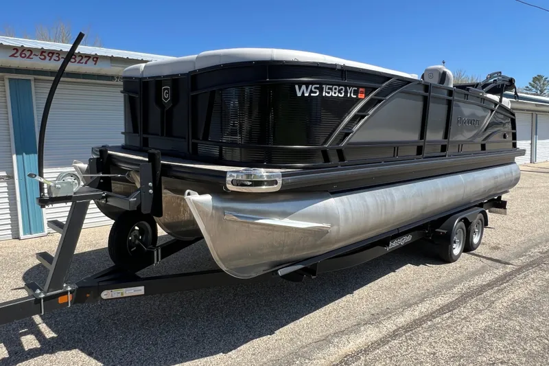 Slide: The Image of 2023 Godfrey Monaco 235 SB pontoon boat on trailer, parked outdoors. - 4