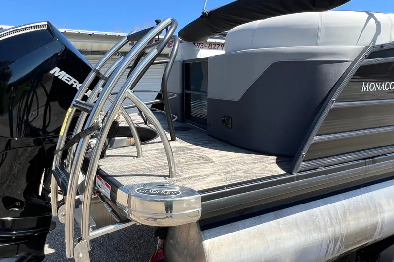 Slide: The Image of 2023 Godfrey Monaco 235 SB pontoon boat with Mercury engine and sleek design. - 7