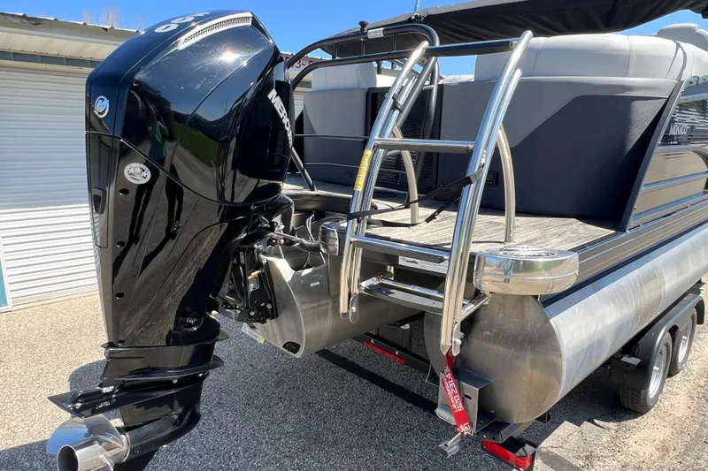 Slide: The Image of 2023 Godfrey Monaco 235 SB pontoon boat with powerful outboard motor and sleek design. - 8