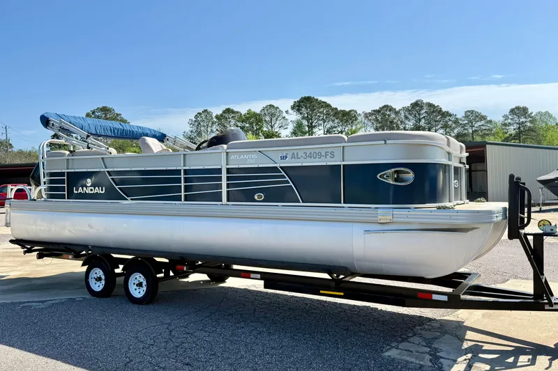 The Image of 2015 Landau Signature 2500 Cruise pontoon boat on trailer, parked outdoors. - 0