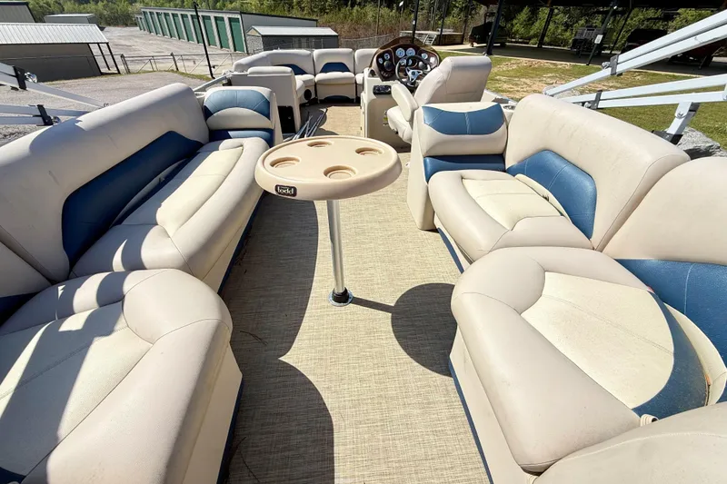 Slide: The Image of 2015 Landau Signature 2500 Cruise pontoon boat interior with beige and blue seating. - 10