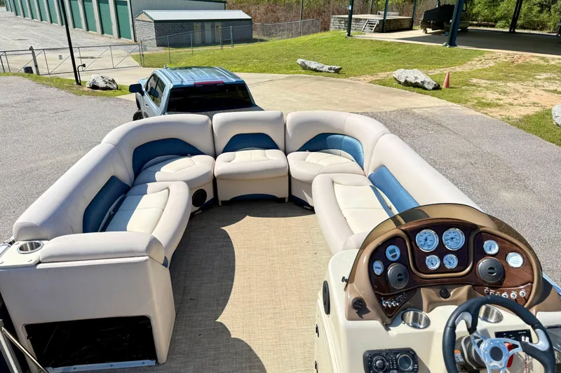 Slide: The Image of 2015 Landau Signature 2500 Cruise pontoon boat with plush seating and modern dashboard. - 13