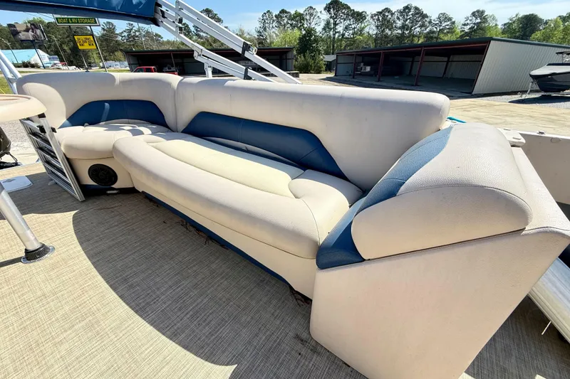 Slide: The Image of 2015 Landau Signature 2500 Cruise boat seating area with beige and blue upholstery. - 19