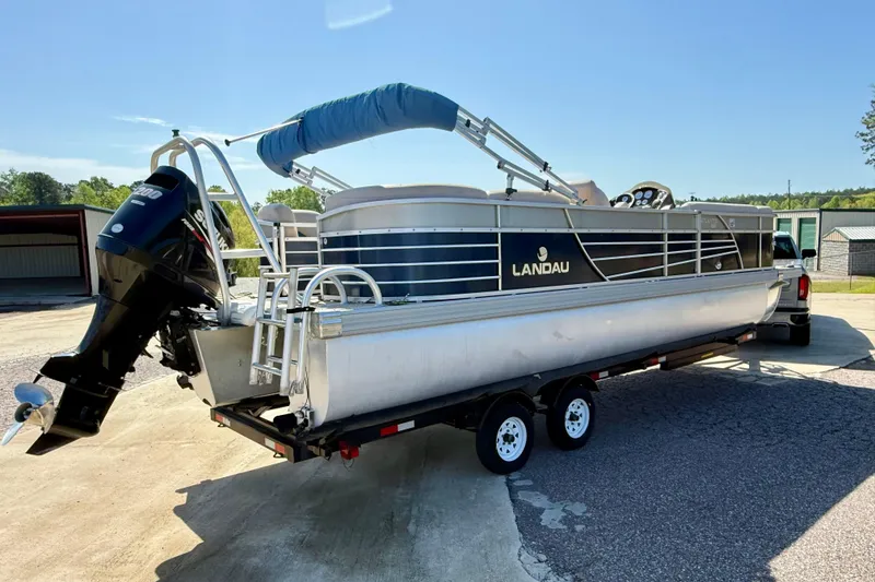Slide: The Image of 2015 Landau Signature 2500 Cruise pontoon boat on trailer, parked outdoors. - 2