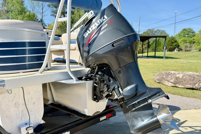 Slide: The Image of 2015 Landau Signature 2500 Cruise with Suzuki outboard motor, parked on a sunny day. - 4