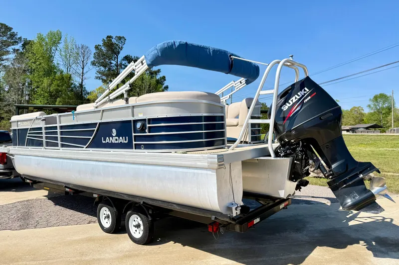 Slide: The Image of 2015 Landau Signature 2500 Cruise pontoon boat with Suzuki outboard motor on trailer. - 5