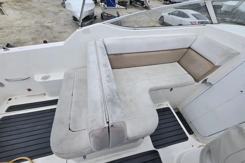 Slide: The Image of 1996 Wellcraft 26 Exel SE boat interior with white and beige seating. - 11