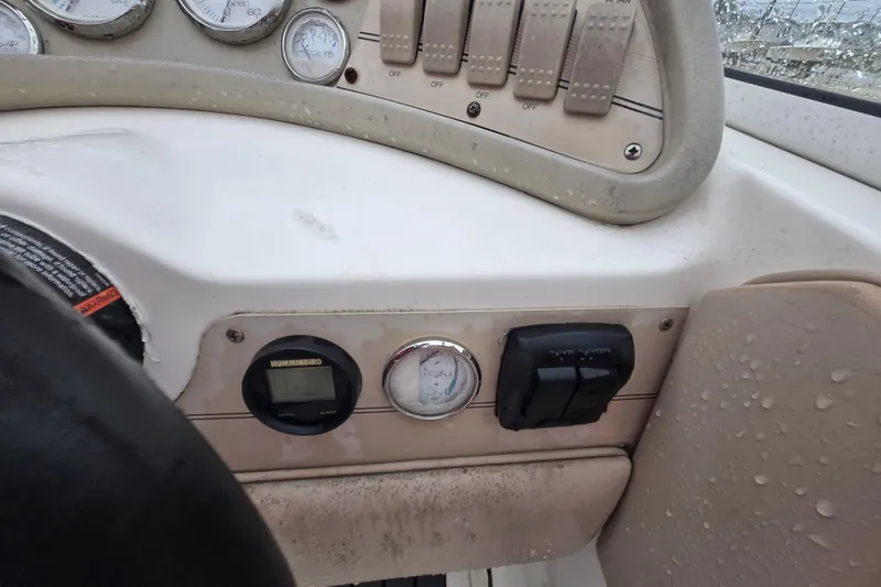 Slide: The Image of Dashboard of a 1996 Wellcraft 26 Exel SE boat with gauges and controls. - 14