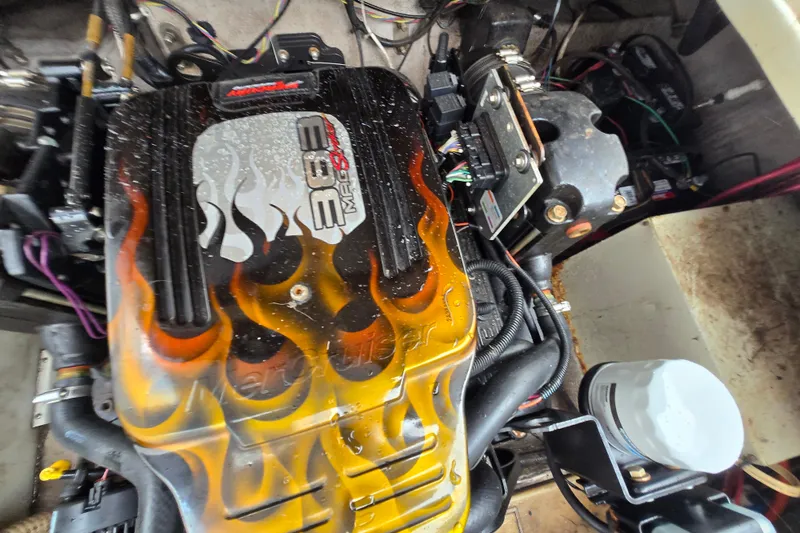 Slide: The Image of Engine of a 1996 Wellcraft 26 Exel SE with flame design on cover. - 2