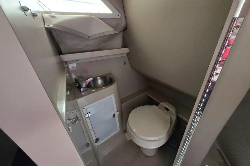 Slide: The Image of 1996 Wellcraft 26 Exel SE boat bathroom with sink and toilet. - 20