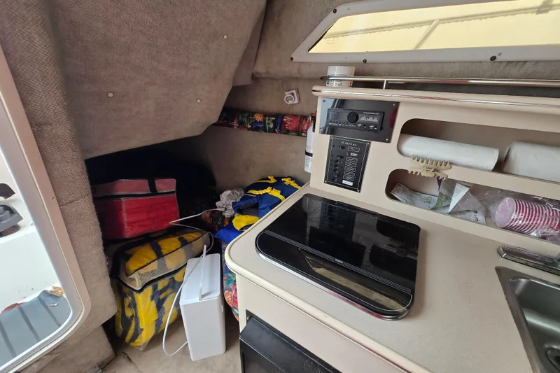 Slide: The Image of Interior of a 1996 Wellcraft 26 Exel SE boat with storage and control panel. - 21
