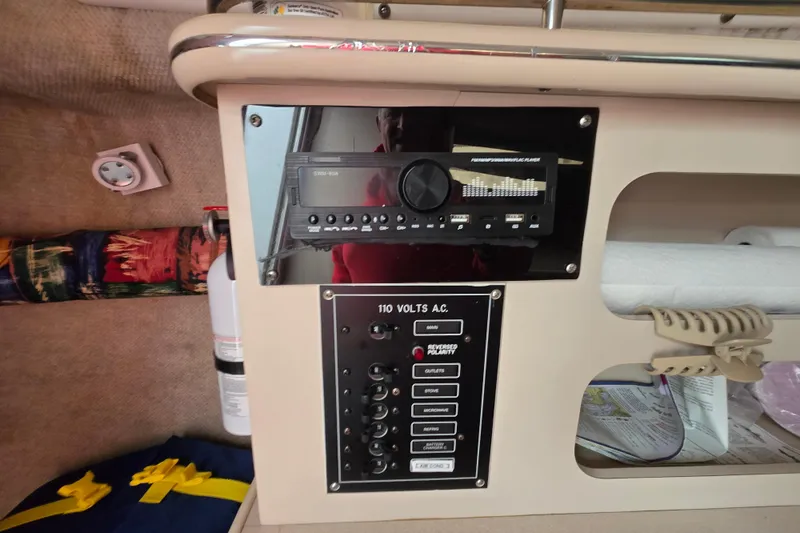 Slide: The Image of 1996 Wellcraft 26 Exel SE cabin interior with control panel and stereo system. - 22