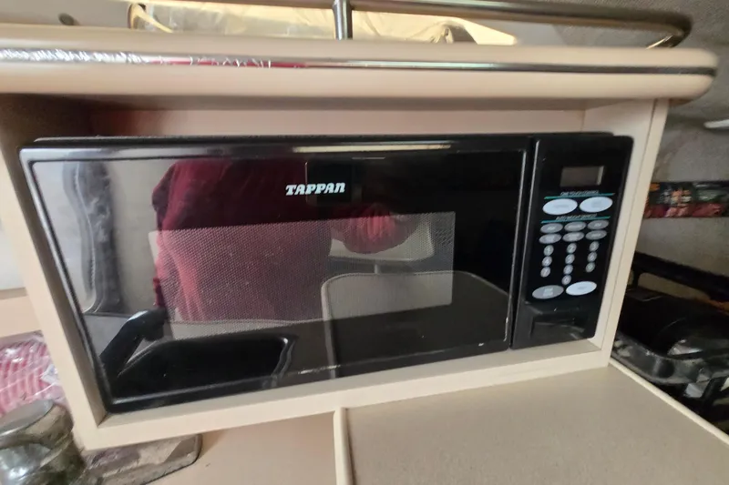 Slide: The Image of Built-in Tappan microwave in 1996 Wellcraft 26 Exel SE boat interior. - 23