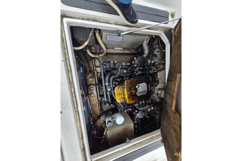 Slide: The Image of Engine compartment of a 1996 Wellcraft 26 Exel SE boat, showing detailed components. - 28