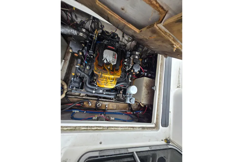 Slide: The Image of Engine compartment of a 1996 Wellcraft 26 Exel SE boat, showcasing detailed mechanics. - 29