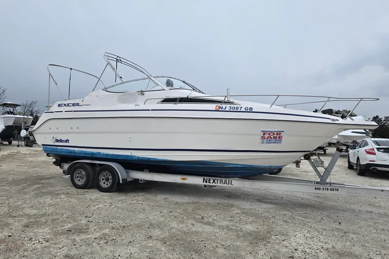 Slide: The Image of 1996 Wellcraft 26 Exel SE boat on trailer, for sale sign visible. - 4